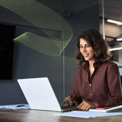 Woman sits at laptop. Two Strategies for Effective Business Cases in 2025.