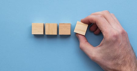 Hand chooses a wooden block